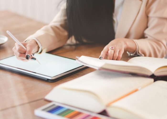 Cropped shot of young beautiful businesswoman working on her project with digital tablet in comfortable office room